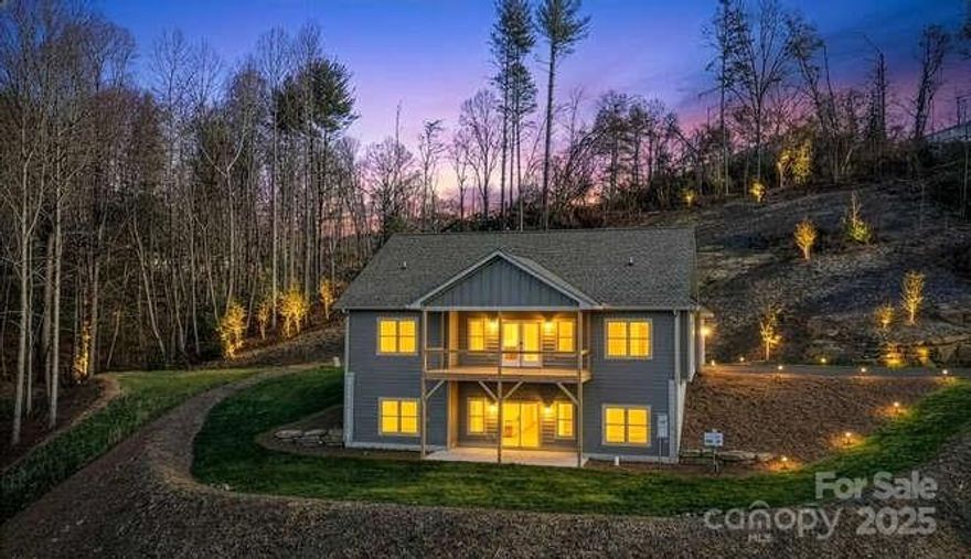 Discover exceptional new construction on Hutch Mountain in Fletcher, NC, tucked within a desirable gated community offering privacy, security, and a peaceful mountain setting. This home is situated on a truly unique private lot at the end of a cul-de-sac, not shared with any other homes, creating a rare sense of seclusion. Enjoy beautiful long-range views from the covered back porch, perfect for relaxing or entertaining while taking in the natural surroundings. The main level offers 1,759 square feet of thoughtfully designed living space with two bedrooms and an open, functional layout. The finished basement adds an additional 1,502 square feet, featuring a versatile bonus room ideal for a home office, media room, or guest space, along with a deep unfinished storage area providing ample room for equipment, hobbies, or future expansion and a third bedroom. A two-car garage adds everyday convenience. This property combines modern construction, generous square footage, and a premium mountain location just minutes from Fletcher amenities.
