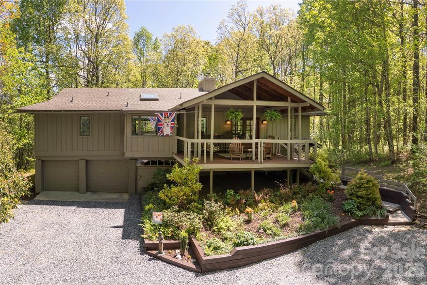 Welcome to your mountain sanctuary, a retreat nestled among the lush ferns and tall hardwoods, offering unparalleled peace and tranquility. This multi-generational home is designed for those who appreciate nature's beauty while blending privacy, comfort, and convenience.  
Step inside to an open living area great for today's lifestyle. Natural light floods the modern kitchen and dining area, creating an inviting atmosphere for entertaining family and friends. Cozy up on chilly evenings by the stunning stone wood-burning fireplace, perfect for unwinding after a day of outdoor adventures.  The kitchen is equipped with modern appliances and ample granite counter space. Whether you're preparing a casual meal or hosting a dinner party, this space caters to all your culinary needs.  
Step outside onto the large, serene front porch or screened back porch, where you can sip your morning coffee while soaking in the crisp mountain air. This peaceful outdoor oasis is perfect for enjoying the beauty of nature in complete privacy.
The fully finished lower level is a true gem! With a separate private entrance, it can easily serve as a business retreat, guest suite, or long-term studio rental. Complete with roomy living and sleeping areas, a bath, a wet bar, mini refrigerator, range & oven, and private covered porch this versatile space offers countless possibilities to suit your lifestyle.  The home's large 2-car garage provides ample storage space, ensuring your vehicles and outdoor gear are safe and secure. Updates include beautiful hardwood flooring throughout the main level, a tankless water heater, radon mitigation system, and Aeroshield insulation in the attic for low utility bills.
This home is not just a residence, it’s a lifestyle. Experience the joy of living in a serene environment while still being conveniently located near downtown Brevard, one of America’s Coolest Small Towns, the Pisgah Nat'l Forest, and the Blue Ridge Parkway. Don't miss your opportunity to own this extraordinary western North Carolina property!