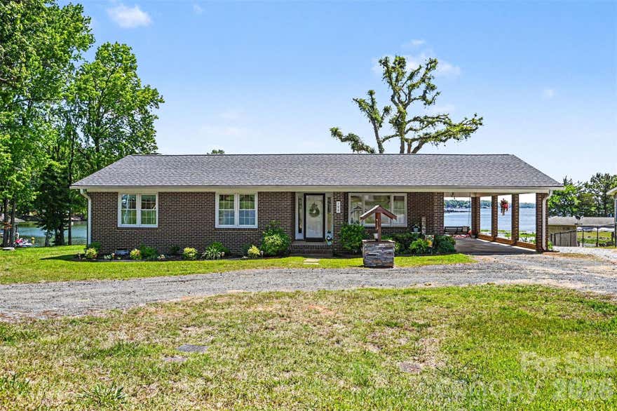 Welcome to lakefront living on beautiful Lake Tillery! This charming waterfront home offers a rare flat lot with stunning water views and the perfect setting for relaxing or entertaining. Inside, you'll find a bright and open floorplan filled with natural light, creating an inviting lakeside atmosphere. The home is being offered furnished, making it move-in ready for a full-time residence, weekend getaway, or vacation rental opportunity. Enjoy easy access to the water with your own boathouse, plus plenty of outdoor space to enjoy lake days, morning coffee, or evening sunsets. Conveniently located close to area shops and restaurants, this property combines peaceful waterfront living with everyday convenience. Don't miss the opportunity to own your slice of Lake Tillery! Home also features a newly renovated pier.