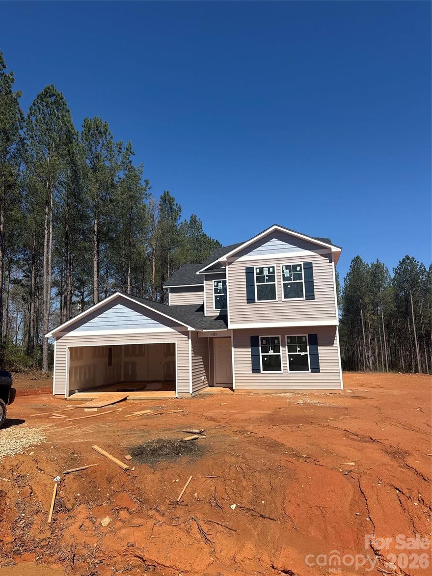 Welcome to this beautiful new construction home in Mooresboro, NC, offering 2,204 sq ft with a spacious open floor plan. The kitchen features granite countertops, a kitchen island with seating, and a stainless steel appliance package that includes a flat-top range, over-the-range microwave, and dishwasher. The primary bedroom boasts a vaulted ceiling with an installed ceiling fan, two walk-in closets, and a private ensuite bathroom. The primary bath includes double vanity sinks, a separate garden tub and shower, and a private water closet. The lower level offers a large bedroom/bonus room that is perfect for an additional bedroom, guest space, or home office. Conveniently located near many main attractions, this home is truly a must-see.