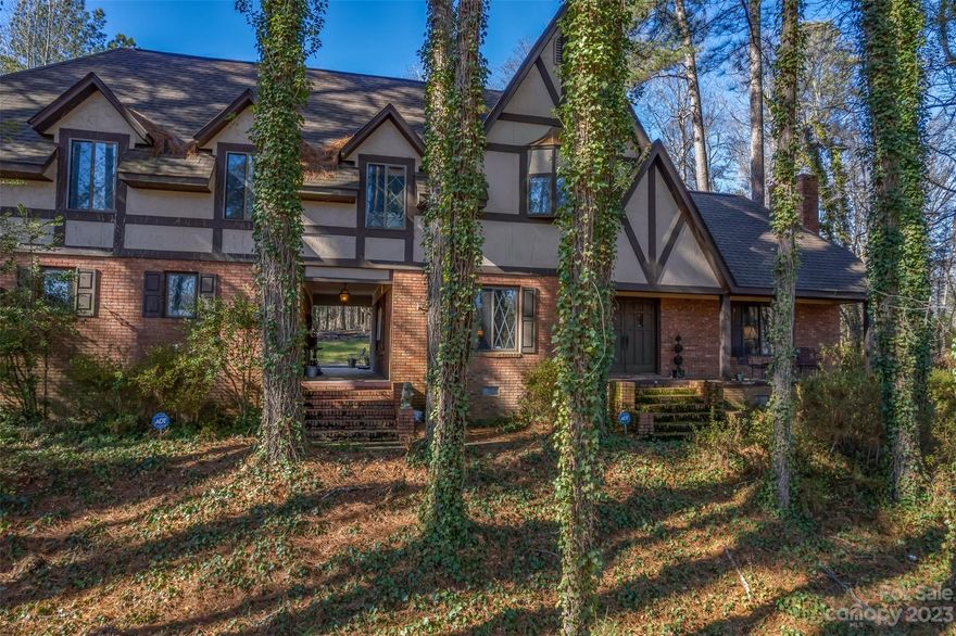 One of the few Tudor homes in the area! This home sits on 2.18 acres and overlooks a creek and farmland across the street. The location is very convienent as it is only a mile from the 221 and 74. Inside you can enjoy the solid woodwork throughout the home, the cozy kitchen with a window seat, and the brick fireplace in the den. There is a large living room that can be made into a great family room. The bedrooms and full baths are located upstairs. Off the primary suite is a beautiful covered porch overlooking the yard. One of the great features is the oversized two car garage connected to the home by a quaint breezeway. There is plenty of parking. Professional photos coming soon.