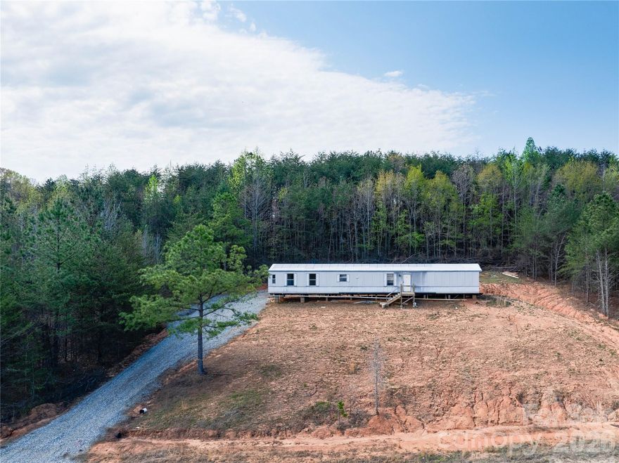 Investor Special with Major Upside Potential! This 2000 Redman single wide presents an excellent opportunity for investors, flippers, or those looking to build equity through finishing touches. Situated on a generous .58-acre lot with a newly installed gravel driveway and conveniently located just minutes from the South Carolina border, this property offers both accessibility and the appeal of quiet country living.

The home is already well underway through a full renovation, with fresh sheetrock installed throughout and a beautifully updated kitchen featuring new cabinetry and countertops. Both bathrooms have been upgraded, including a refreshed primary bath with new vanity, toilet, and tub/shower combo, along with updates in the secondary bath. Major infrastructure improvements have already been handled, including connection to city water and a brand-new 3-bedroom septic system installed this year.

This property is ready for the final phase of completion and will require underpinning, power connection (Duke Energy), electrical completion, HVAC installation, and appliances—making it an ideal project for investors looking to add value and maximize return. With no known restrictive covenants and no road maintenance agreement, the flexibility here adds even more appeal.

Seller holds title in hand (not detitled). Outbuilding does not convey. Property is priced to sell and offers a strong value-add opportunity in a growing area—don’t miss your chance to bring this project across the finish line and capitalize on its potential