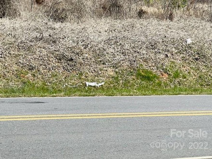 Nice lot 1/2acre lot ready for building with a slope towards the county highway.