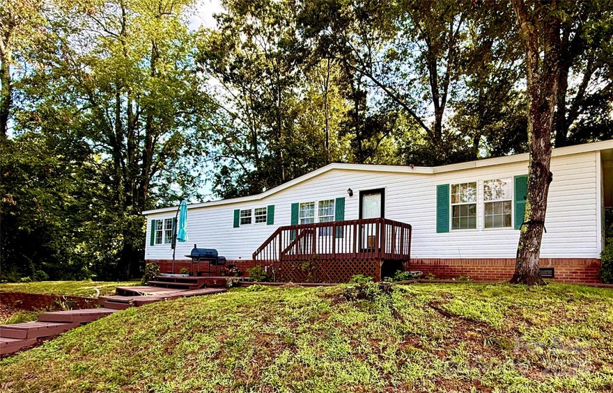 Seller wants to sell! Now offering all closing costs paid by seller up to $10,000 with an acceptable offer. Combine that with the 1% buy own credit with approved lender for buyer to use at their discretion.  This could mean little to no cash out of your pocket to own a home! Welcome to 51 Farmstead!  A beautifully maintained 3-bedroom, 2-bathroom home nestled in the peaceful countryside of Leicester. Enjoy stunning rolling hill and mountain views from your front porch, offering the perfect backdrop for calm mornings or evening gatherings.
Step inside to an open floor plan filled with natural light and freshly painted interiors. The primary bedroom features a walk-in closet and an en suite bathroom with a large soaking tub. The main living area flows seamlessly into the kitchen and dining space, ideal for entertaining or everyday living. (most furniture included!)
Outside, you'll find a fenced-in yard perfect for pets or play, plus a separate hangout area tucked away in a wooded corner-your own private retreat. The freshly painted shutters and deck add to the home's charm.
Whether you're looking for space, views, or a peaceful lifestyle just a short drive from Asheville, this home has it all. Come experience mountain living at its finest.