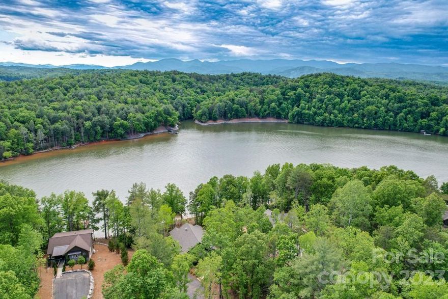 Brand new custom Luxury home on Lake James! Buyers will love the open floor plan, w/ high end details throughout! Gourmet eat in kitchen w/large island & stainless appliances is open to the spacious living room w/ fireplace & covered porch w/stone fireplace overlooking beautiful Lake James! Primary suite on main level features large walk in closet & spa like bath. Another bedroom/secondary primary bedroom w/ private bath & half bath is great for guests! The lower level has 2 additional bedrooms, a full bath, laundry room & spacious bonus room for entertaining! Lower covered porch is great for relaxing, entertaining & enjoying the open water & mountain views. Easy access to 2 level, double boat dock w/ room for all of your water toys. Great STR option as The Arbors is a gated community w/walking trails, community pavilion picnic area, fenced boat storage & close to downtown Marion shops & restaurants. Minutes to Lake James State Park & Fonta Flora Trail for hiking, biking & exploring.