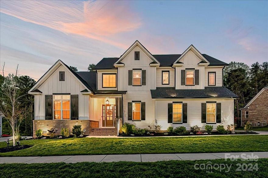 Your Dream Home awaits you! Stunning Home w/Farmhouse Exterior Colors situated on Private Lot located in Award winning Fort Mill Schools! Enter through the Custom Front door to Soaring Ceilings & Architectural Features. Amazing Office w/Vaulted Ceilings! Oversized Dining Rm w/extended Height & Tray Ceiling! Wide Plank Wood Flrs! Impressive Kit w/DBL Stacked White Cabinets w/Soft Close, Dbl Wall Ovens & Micro. Wall Mounted SS Vent Hood, Farmhouse Sink, Custom Tiled Backsplash, Expanded Island! Quartz Counters! Butler's Pantry w/Bev Refrig. Kit overlooks Great Rm w/Built-in Shelving & Stone FP! Primary-Main w/Tray Ceiling, Custom Walk-in Closets, & Glamorous Bath w/Separated Vanities, Garden Tub & Huge Walk-in Shwr w/Bench seat. Upper Level Hall w/Wood Flrs. Bonus Rm w/Barn Door & Walkin Storage. Generously sized Bdrms. Outdoor Living too! Custom Patio w/Subterranean Firepit, Covered Rear Porch, Fenced Yard! Full Irrigation, Extended driveway, Painted/Finished Garage w/Epoxy Garage Flr.