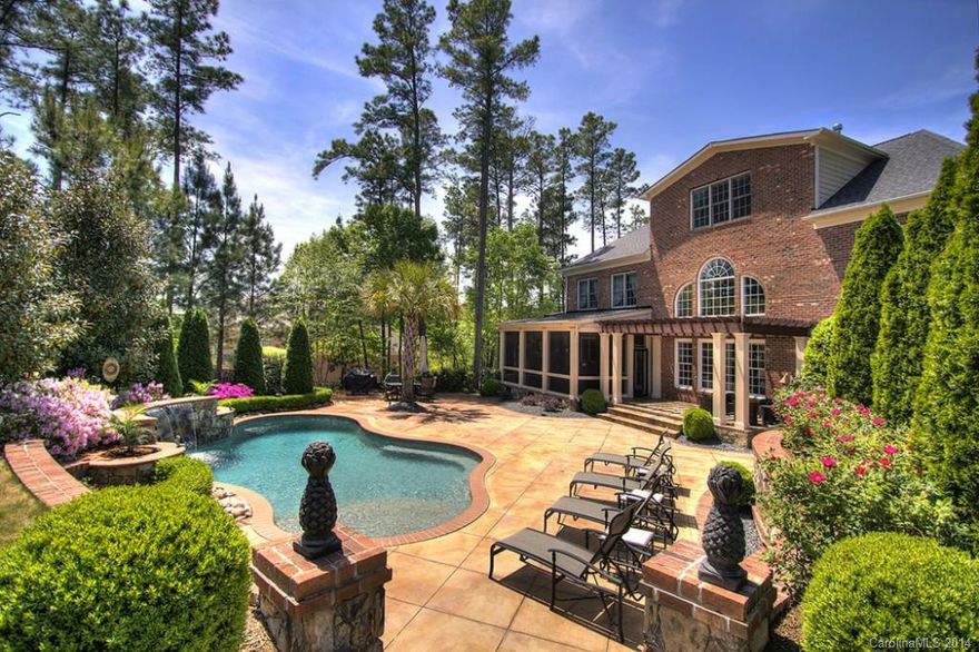 This home is truly an OASIS!  Shows like a model!  Hardwood floors throughout most of the house.  Granite countertops, cherry cabinets, brand NEW carpet in secondary bedrooms, NEW cooktop to be installed May 10th, built-in wine fridge and butler's pantry, the owners retreat and closet are AWESOME!  New in 2010 - screened-in porch with gas fireplace, flagstone flooring, pergola, pool with waterfall, lavish landscaping creating a truly private PARADISE!  Must check out the photos!