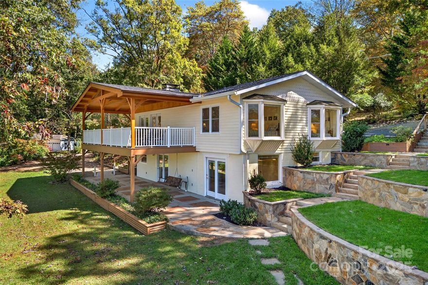 Welcome to one of the most sought-after addresses in Black Mountain—211 Rhododendron Avenue. Perfectly situated on Lake Tomahawk and just a short walk to downtown shops, dining, and galleries, this 4BR/3BA home offers the best of mountain living and small-town charm.Step inside the bright and airy great room, where soaring ceilings and a floor-to-ceiling stone fireplace create a warm gathering space. The open plan flows seamlessly to the newly covered porch, an ideal spot for morning coffee or evening sunsets overlooking Lake Tomahawk. With the lake, walking track, tennis courts, and recreation area just steps away, outdoor enjoyment is at your doorstep.

The lower level was thoughtfully designed with rental potential or multi-generational living in mind. One side features a bedroom, bath, kitchen, and living area. The other side offers another living area, bedroom, and bath. Each has a private entrance, patio, and the option to be closed off from the main level—making them excellent for guests, short-term rentals, or extended family.

Whether you’re searching for a full-time residence, a vacation retreat, or an investment in one of Western NC’s most beloved communities, this property is a rare find.