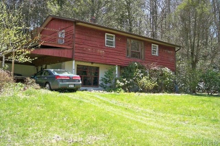 Solid hemlock sided home has land to the rear that would make excellent second home/RV site. Good spring & creek flowing through.. Large light basement . Great locationfor artist studio. Solid concrete block foundation Needs some electric and plumbing updating. Assessed at $98,350.  Unique bushes, perennials, and trees. Grounds organically maintained for decades.  five minutes from the Celo Health Center, Celo Food Coop, and the pristine South Toe River. Near. Blue Ridge parkway. Near Asheville.