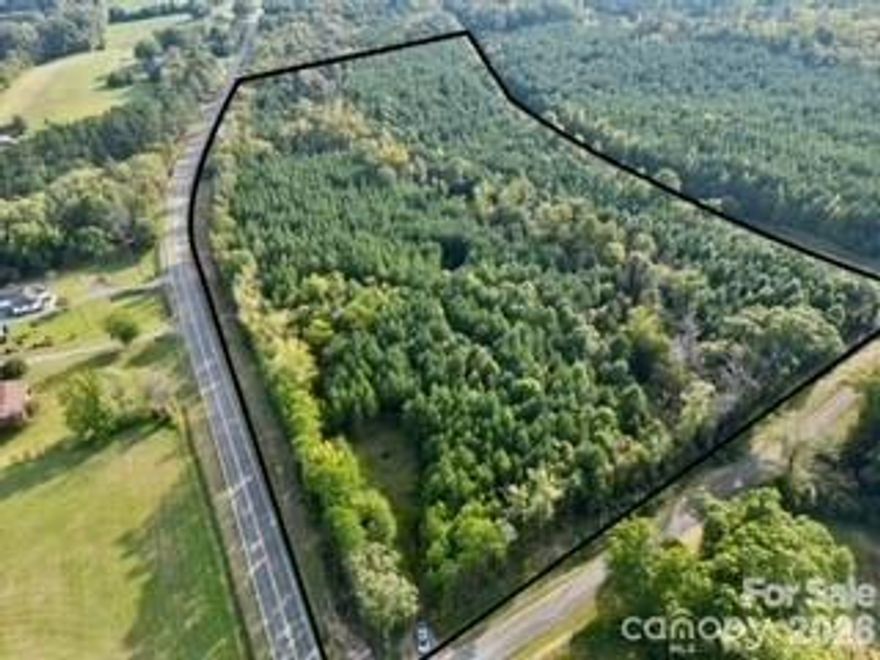 Soil Scientist Report attached. Beautiful 23-acre wooded property offering privacy, natural beauty, and convenience. Located at the corner of Hwy 52 and Southbound Rd with substantial road frontage on both roads. The land features mature loblolly pines, well-defined trails, and scenic Jacobs Creek running through the property.

Perfect for nature enthusiasts or anyone seeking a peaceful retreat. Ideal for hiking, hunting, camping, or building your dream home surrounded by nature. Rear boundary runs along railroad tracks parallel to Hwy 52, adding unique character.