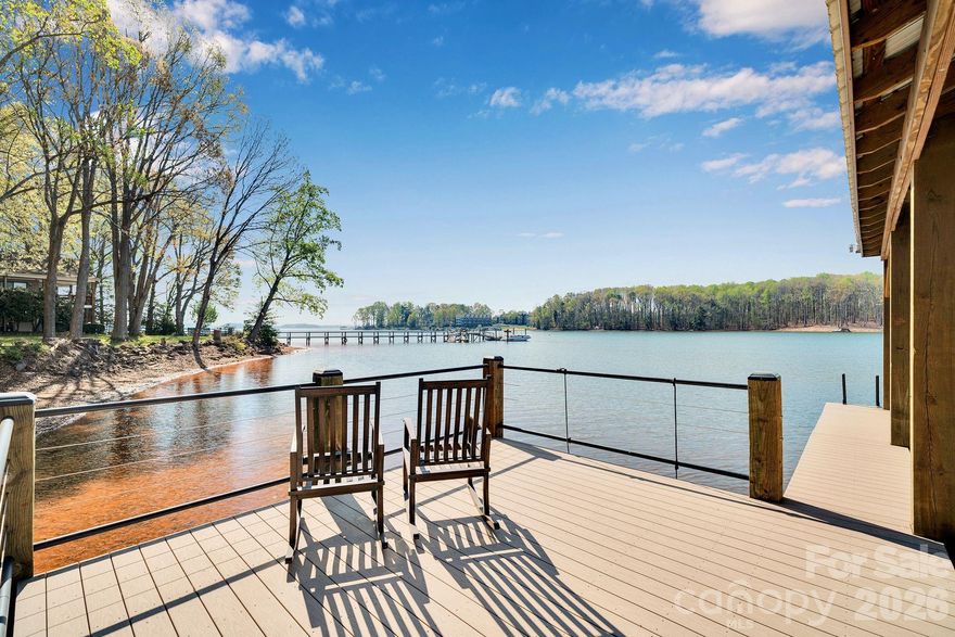 Stunning 4 bedroom, 3 bathroom, 1.5 story waterfront home on Lake Norman! Custom built in 2022, this beautifully designed home sits on a flat lot with expansive cove views and a peaceful natural forest backdrop. Enjoy the ultimate lake lifestyle with a covered dock featuring Trex decking and a 10,000-lb boat lift, plus a white sandy beach and recently dredged dock area (2024) for improved water access.

Designed for year-round enjoyment, the home features a heated and cooled EzeBreeze 365-day room, perfect for relaxing while overlooking the water. Inside, the home showcases white-washed oak hardwood floors throughout the main level, high ceilings, and a striking coffered ceiling in the great room. Elegant details include crown molding, full-height cabinetry, wainscoting accents, custom built-ins, and abundant natural light from large casement and picture windows.

The chef’s kitchen blends style and function with quartz countertops, a large island, marble backsplash, Bosch appliances, and custom off-white cabinetry extending to the ceiling, along with a walk-in pantry with custom shelving. The primary suite and bathrooms feature luxury finishes including a custom glass shower enclosure with Ferguson fixtures, a multi-jet spray system, decorative marble accents, and custom closet systems. A convenient drop zone is located just off the oversized 3-car garage for busy lives. Upstairs, you'll find a large bonus room and 2 additional bedrooms and a full bathroom. 

Located on the desirable southern side of Denver, this home offers convenient access to highways, shopping, and restaurants. No HOA means short-term rentals may be an option, and with county water and sewer already connected, there may be room to add a pool.

An exceptional opportunity to enjoy modern luxury and the best of Lake Norman waterfront living!