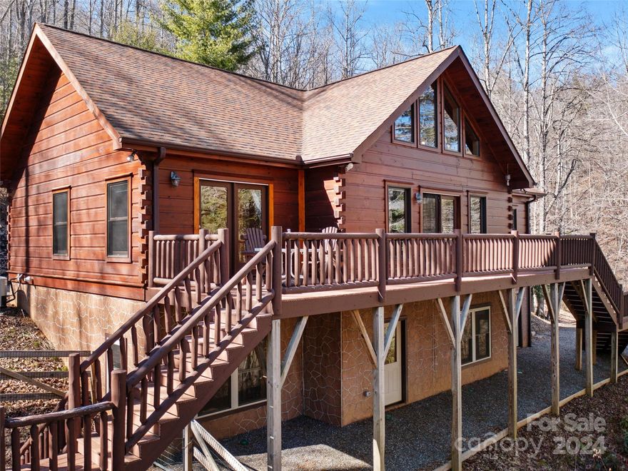 This perfect log cabin is turnkey ready and located in a beautiful gated community along the bold rushing waters of Crabtree Creek. Mountain Brook Estates offers many common areas and hiking trails including a local favorite, Crabtree Falls. This true log cabin offers a large great room with vaulted wood ceilings, open to the kitchen and dining area, with large windows, allowing light to flood in from the room’s front and back. The main level also has a primary bedroom and bathroom with stand up shower, dual vanity and walk-in closet and a walkout entrance to the porch. A guest bedroom, full bath, and convenient mud/laundry room with outside entrance complete the main floor. The spacious lower level adds an additional bedroom and bonus room, a full bathroom, private walkout, and two large unfinished spaces for future expansion. The cabin is pet friendly with scraped engineered hardwood flooring on the main, laminate wood flooring on the basement level and a fenced yard in the back.