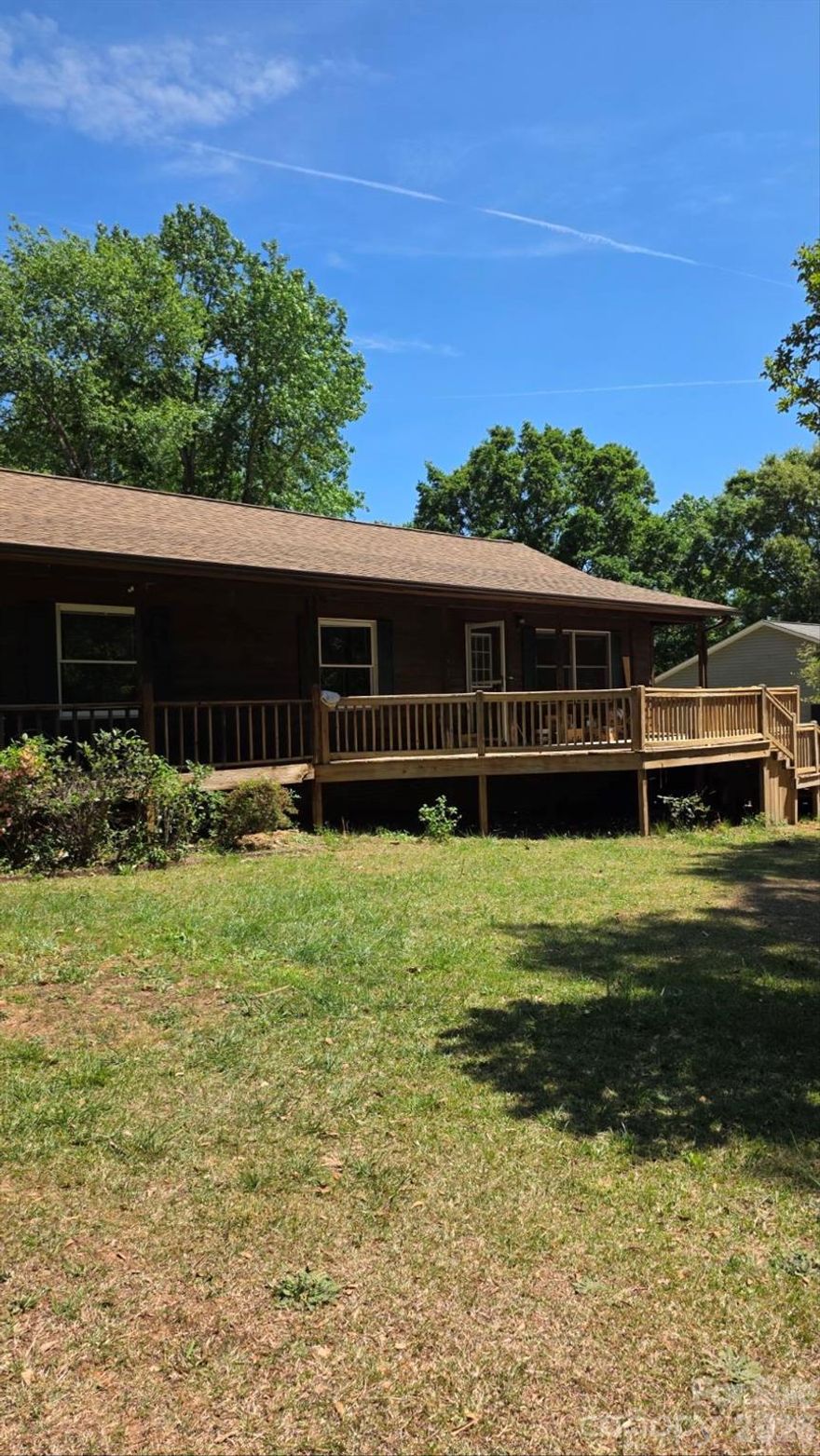 Welcome home to this charming 3-bedroom, 2-bath ranch in Denver's beloved Country Valley community! The moment you walk through the door, soaring vaulted ceilings finished in rich, warm hardwood stop you in your tracks — a dramatic architectural statement rarely found at this price point. Hardwood floors flow throughout, complemented by fresh interior paint and updated bathroom flooring, giving the home a clean, elevated feel. The enclosed sunroom with new sliding doors is your year-round retreat — morning coffee, evening wine, or weekend entertaining without the heat or pollen. Step outside to a large front porch made for rocking chairs, and an expansive back porch overlooking a fully fenced backyard perfect for pets, play, and gatherings. A storage shed with attached playground conveys. Located minutes from Lake Norman, shopping, dining, and Lincoln County schools. Sold as-is — inspections welcome. Priced to reflect condition and opportunity, with room to add your personal touch. Buyer to verify all information including permits. This one has the bones, the charm, and the location — come see it!