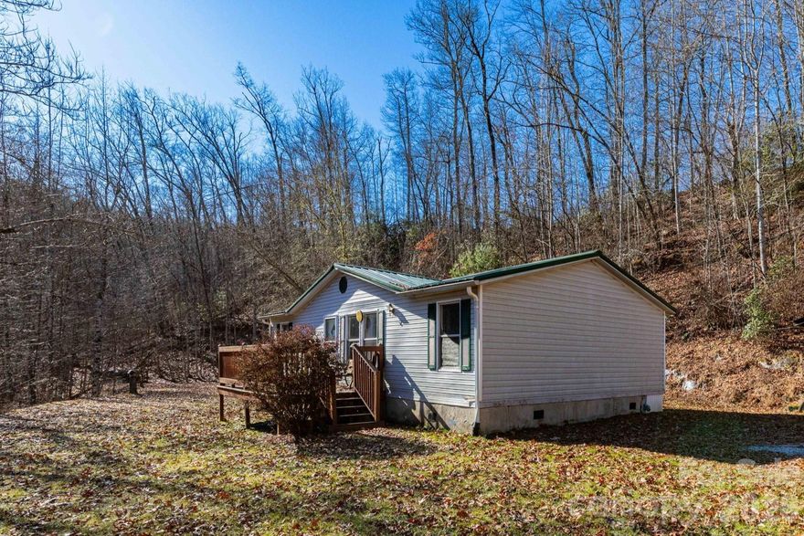 If seclusion, space, and a true connection to nature are at the top of your list, this property delivers. Set on two private acres and directly adjoining Pisgah National Forest, this inviting home offers rare access to endless outdoor adventure right from your backyard. Recent improvements include a newer well, updated flooring, fresh paint, modern appliances, and an efficient heating and cooling system—making it move-in ready and easy to enjoy. The home features three bedrooms and two full baths, providing comfortable living with room to spread out. Step onto the front porch to unwind to the soothing sound of a nearby stream, or explore the surrounding land and forest trails just beyond your property line. Ideally located just five minutes from Cathedral Falls, approximately 15 minutes from the Pisgah Astronomical Research Institute (PARI), and about 30 minutes from both Brevard and Lake Toxaway, this peaceful retreat offers privacy, natural beauty, and convenient access to some of Western North Carolina’s most sought-after destinations.