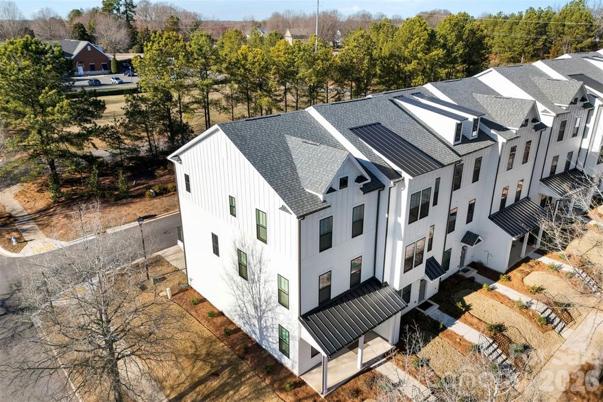 Enjoy the ultimate Fort Mill lifestyle in the heart of sought-after Baxter Village- where you truly live, work and play. This master-planned community is known for its charming streetscapes, sidewalks, scenic walking trails and resort style amenities that encourage an active, connected way of life. Step outside and walk to top-rated school, the YMCA and dining, shopping and nightlife.  With everything just moments away, Baxter Village offers the perfect blend of convenience, community and small-town charm. Ideally positioned just minutes from I-77, this residence combines convenience with an elevated lifestyle in one of Fort Mill's most desirable master-planned communities.

The thoughtfully designed open-concept main level showcases a gourmet kitchen featuring an oversized quartz island, stainless built-in-stove, range hood, dishwasher and microwave- a stylish yet functional space perfect for entertaining and everyday living.  High-end finishes, generous cabinetry and abundant natural light enhance the home's modern appeal, while the end-unit location provides added privacy and windows throughout. Private, attached, rear entry two-car garage for convenient parking and storage.

Four bedrooms, 3.5 baths, allow flexibility for guests, a private home office, or multigenerational living. Enjoy low-maintenance living with walkable access to premier amenities, boutiques, dining, community events and more!  Truly move-in-ready, this home offers the perfect canvas to personalize and make your own.