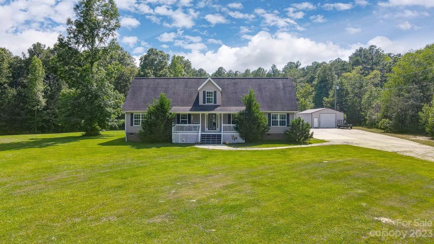 Wonderful, spacious 4BR home on 2.5 acres w/huge detached garage & workshop w/electric. Enormous master + guest bedroom w/ full bath on main. Open, white kitchen has island w/ electric cooktop & sink, wall oven, tons of counter / cabinet space & backsplash open to dining area. Large living room plus office w/ glass panel doors. Master bath has dual vanity, jetted tub & separate shower. Upper features a huge bonus flanked by 2 additional spacious bedrooms each w/ full bath! One of the upper bedrooms plus both upstairs bathrooms have updated vinyl flooring. Enjoy lazy days & evenings on the covered rocking chair front porch or large deck. Enormous flat yard awaits you & offers plenty of space for kids and/or pets, a garden or pool. Detached, 20'x50' metal garage has electric & multiple access doors so is perfect for a workshop, business and/or additional storage. This is a perfect family home offering ample space, bedrooms & acreage. Just a short drive to Hwy 9, 521 & downtown Lancaster.
