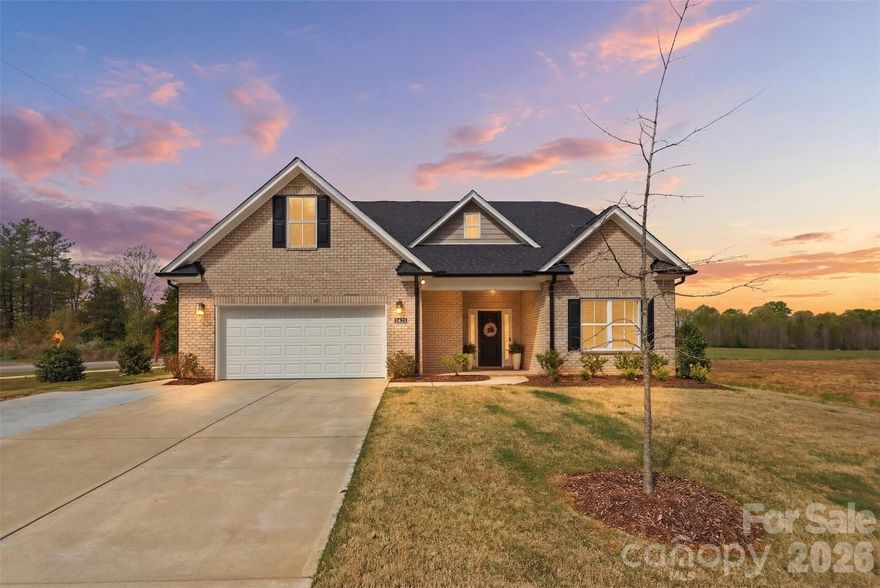 Welcome to this stunning former model home, thoughtfully designed with all the builder’s top upgrades and kept in like-new condition—built just 2 years ago with all warranties still in place for peace of mind.

From the moment you step inside, you’re greeted by a wide, welcoming foyer that sets the tone for the home’s open and inviting feel. This full brick beauty offers an airy layout with gorgeous LVP flooring, neutral designer tones, and abundant natural light throughout.

The heart of the home is the beautiful white kitchen, featuring quartz countertops, a large island with sink and seating, subway tile backsplash, and stainless steel appliances—all flowing seamlessly into the expansive living and dining areas, perfect for entertaining or everyday living.

The primary suite on the main level is a true retreat, complete with a spa-like en suite bath showcasing a frameless glass shower with tile surround, separate soaking tub, dual vanity, and enormous walk-in closet. The main level also features an additional bedroom and full bath, ideal for guests or multi-generational living, along with a convenient laundry room.

Upstairs, you’ll find two additional bedrooms, a full bath, and a spacious bonus room, plus a walk-in attic offering excellent storage.

Step outside to enjoy the covered patio with ceiling fan, along with a large extended concrete patio, perfect for relaxing or entertaining. The flat, fenced backyard provides both privacy and functionality. This is an ideal lot for a pool! 

Additional features include a tankless water heater, 2-car garage with side-mount garage door opener, an epoxy-coated garage floor, extended driveway, irrigation system, and man door from the garage to the exterior. 

Located in a newer subdivision of all-brick homes with a low HOA, this home is just minutes from Wesley Chapel, Sun Valley, and Waxhaw shopping, dining, and conveniences.

With the neighborhood continuing to grow in popularity and more new homes being built, this property offers strong future upside—home values in this area will continue to rise, creating an excellent opportunity to build equity over time.

Opportunities like this rarely come available—schedule your showing today before this one is gone.