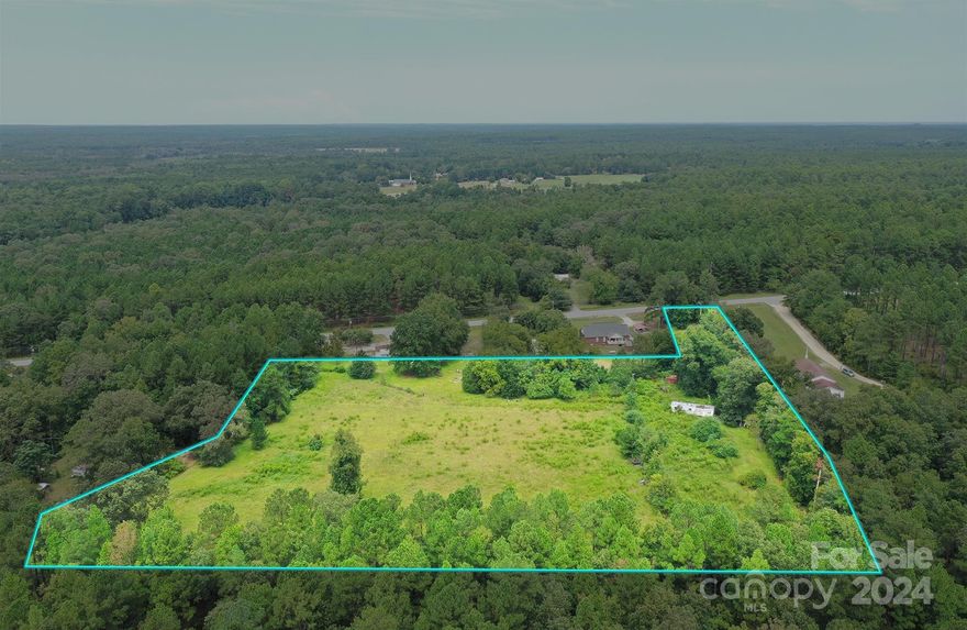Check out this beautiful 4.79 acre flat and mostly clear lot in the heart of Hartsville SC with no restrictions. The land is partially fenced for pasture. There is alligator county water available with a $1800 tap fee.  Mobile homes are ok. No survey or perk test has been done. It would need a septic system.  This lot offers plenty of room for gardening or farm animals.  There is an old single wide trailer home on the property that is being used for storage, but you could make that into a home. It is being sold as-is. The land consists of 3 separate parcels to make the 4.79 acres. Come out today and check it out this one won't last long!