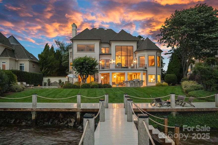 Experience designer luxury in this rare turn-key waterfront estate on one of the most coveted streets in The Peninsula. Meticulously updated and move-in ready, this 6,000+ sq ft home blends timeless elegance with modern comfort. Designed by a professional with exceptional attention to detail, it showcases stunning light fixtures and high-end finishes throughout. The open-concept kitchen flows seamlessly into a cozy family room and soaring two-story great room—ideal for entertaining and everyday living. Five spacious bedrooms and 6.5 spa-inspired baths span three beautifully finished levels. Enjoy breathtaking long-range views from modern windows, a resort-style backyard with pool, spa, outdoor kitchen, and covered patios. The walk-out basement features a guest suite, gym, and large family room. A deeded boat slip with covered dock and lift completes the ultimate Lake Norman lifestyle. Walk to the Yacht Club and minutes from The Peninsula Club.