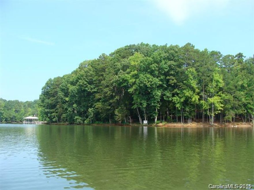 Paradise found. Point lot with 382 feet of Lake Wylie waterfront defines this level, lightly wooded cul de sac lot in Woodland Bay. Gated community of large custom homes at the mouth of the quiet South Fork of the Catawba basin. Plenty or room for a pool and amazing lakeside hardscape. Easy commute to Charlotte, airport, freeways