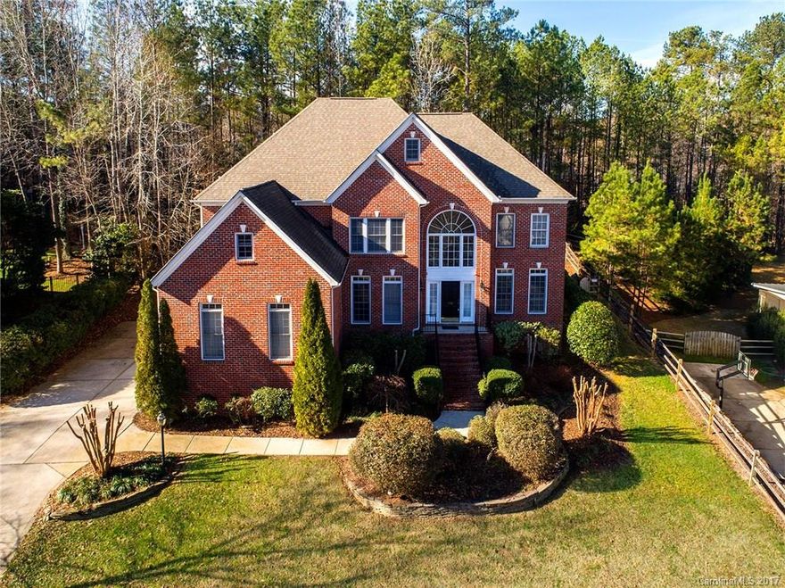 Beautiful 2 Story Brick Home with fenced back yard surrounded by mature trees for extra privacy.  Freshly painted with new carpet. Hardwoods throughout main level. Formal Dining & Living Room,Office and Great Room on main floor.  Kitchen w/ large island opens to Great Room, Pantry, Granite Counters, custom backsplash, lots of cabinet space. Huge Master Suite w/ Walk In Closet to die for. Screened in Porch and large deck for outdoor entertaining. Oversized 3 Car Garage.  A must see!