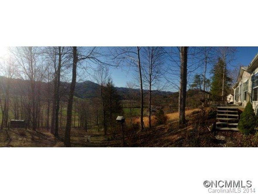 JUST REDUCED! -Your own private Mini-Farm! Nestled against the Pisgah National Forest, this well-cared for and loved home is waiting for you and your family.  Almost 4 acres of land, an area for a garden and also space for chickens and goats. The Home has 3 bedrooms, 2 full baths, eat at kitchen island and a dining room. Front and back have beautiful mountain views. Outside Playhouse/Office has electricity and insulation