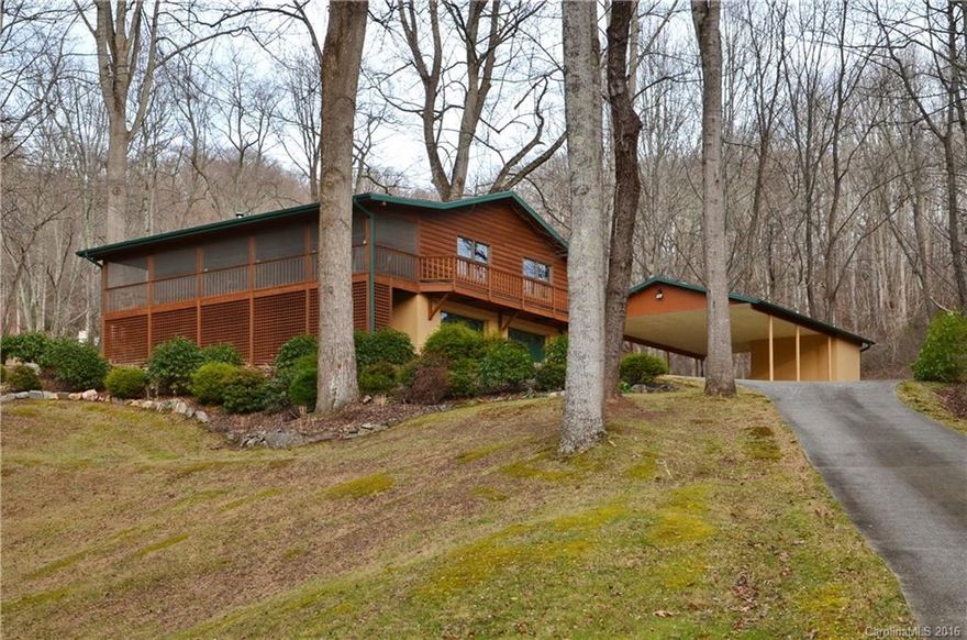 You Can Have It All! 
The feel of country living without the drive.  Just minutes into downtown Waynesville, this 2 bdrm 2 bath log cabin has an open floor plan, vaulted ceilings, 2-car carport, garage, and workshop area. Set on 3 park-like acres, let nature be your decorator. Towering trees, shrubs, stream, and perennials create a breathtaking setting you can enjoy from the screened-in front porch and open back deck. So well cared for and tastefully updated, there’s nothing to do but move in!