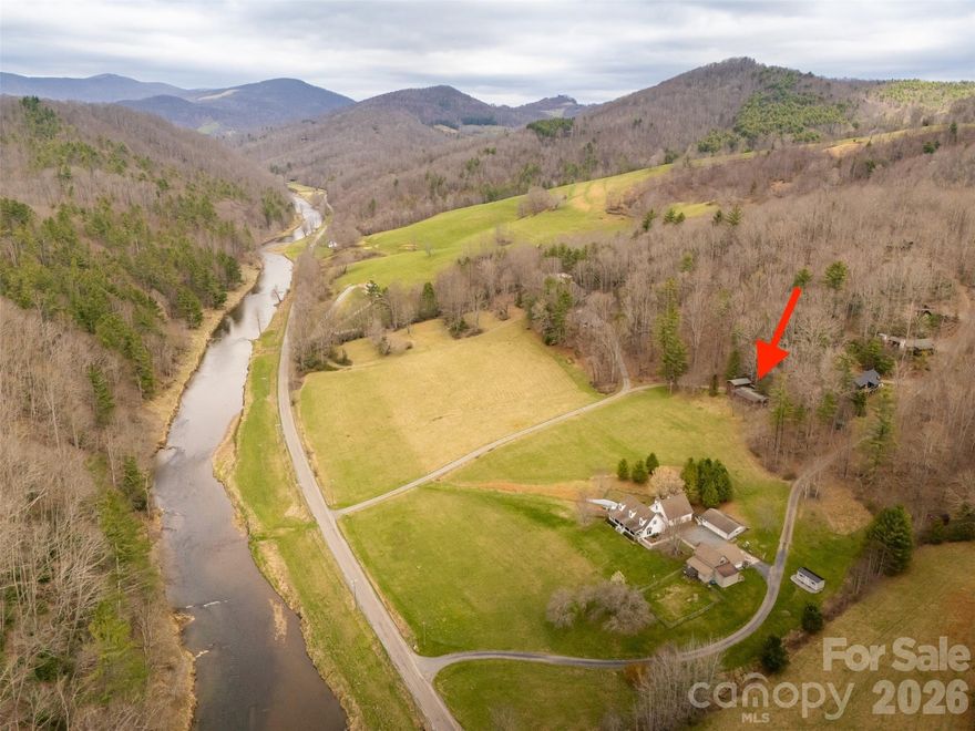 RIVER VIEWS - MAIN LEVEL LIVING - TWO SEPARATE LIVING SPACES - SHORT-TERM RENTALS ALLOWED - CLOSE TO HIGH COUNTRY ACTIVITIES - Experience mountain living in the Historic Todd Community of Ashe County. This unique mountain getaway offers river views in a peaceful mountain setting. Opportunities abound with this home’s versatile layout. The floor plan features two separate living areas, two separate entrances, one full kitchen, one kitchenette, and the ability to lockout one side of the home. Ideal for the “lockout design”, allowing for half the home to be used as a separate rental unit or guest suite. If you are looking for a home that offers two living quarters or multiple rental opportunities, you’ve found it! One side of the home features one bedroom, a bonus room/sleeping area, full bath, full kitchen, living room, dining area, and laundry. The second side of the home includes one bedroom with ensuite bathroom, living room, dining area, and kitchenette. The multiple outdoor living spaces frame the stunning views of the New River. There are two covered porches, an open firepit area, and wooded space. Nearby recreation includes canoeing, kayaking, and tubing on the New River, hiking at Elk Knob State Park or Blue Ridge Parkway, fishing access at Todd Island Park, and mountain biking at Rocky Knob Mtn Bike Park. Convenience is at your doorstep with Boone only 20 min away, West Jefferson 25 min, and Blowing Rock 35 min. Great location for a weekend getaway. Travel Times: Winston-Salem 1 hr 30 min, Charlotte 2 hr, Raleigh 3 hrs. Main Level Bedroom and Bonus Room/Sleeping Area are heated by plug-in electric wall mounted heaters.