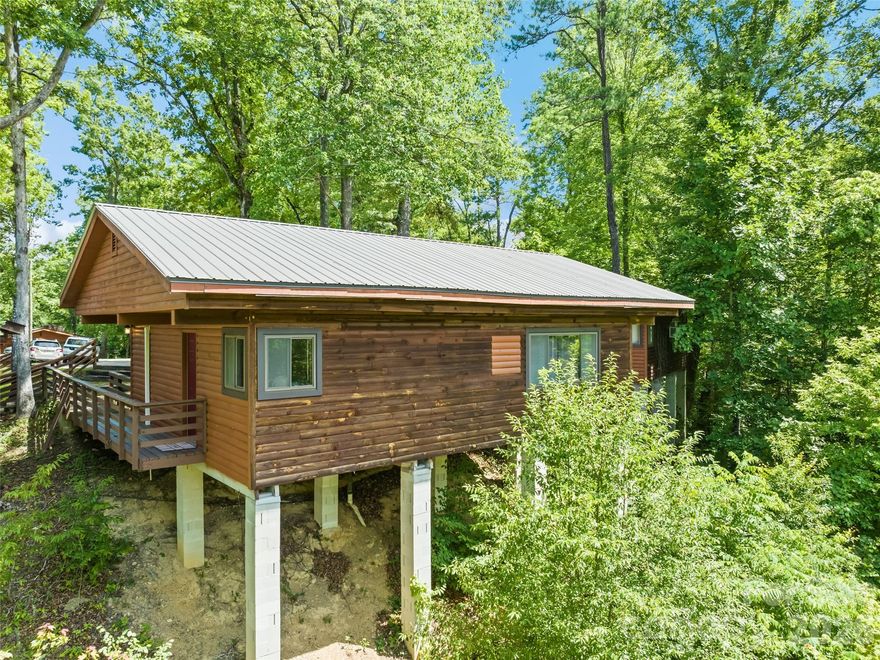 This rustic Bryson City mountain cabin is just what you're searching for! It's a serene get-away, or a fun adventure - convenient, intimate, and comfortable in all seasons. With the warm, tongue-and-groove wood interior, you feel right at home reading, playing board games, entertaining, and gathering together. Guests have privacy with a split bedroom layout, but can still enjoy each other with its open-concept kitchen/dining/living area. Simplicity speaks volumes with the cabin's no-fuss maintenance. Or, investors can explore rental income options for this property. It is minutes from the NOC, Fontana Lake, GSMRR, Cherokee Casino, hiking trails, fishing, dining, shopping, boating, and much more. Further, guests can take advantage of the Resort's many amenities - a fitness center, swimming pool, game room, restaurant/bar, and such. STRs allowed, but no rental history; septic records requested.