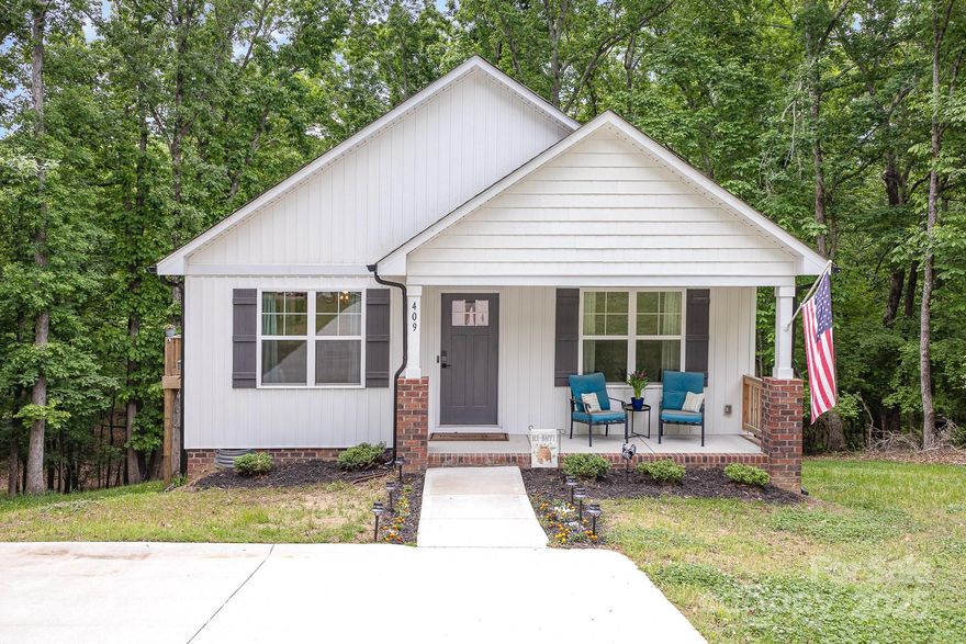 Welcome to your dream home in highly desirable & well-established Woodcrest! This beauty is move-in ready & designed w/everyday comfort & entertaining in mind. Step inside to gorgeous luxury vinyl plank floors & open floor plan. This 3-bed/2-bath charmer features a stylish kitchen w/white shaker cabinets, granite counters, stainless appliances, cozy eat-in area, pantry. Enjoy sunsets from the front porch or grill out on the side deck while soaking in the stunning & peaceful views. Primary Suite has TWO walk-in closets & serene wooded views from the windows. Tech lovers will appreciate the Google Nest doorbell & thermostat, easily giving you comfort & security at your fingertips. Need storage? Spacious crawlspace has you covered! Natural light pours into the home. It’s a retreat you'll never want to leave. Tucked in a PRIME spot just minutes from shopping, dining, & entertainment. This home is the perfect blend of charm, comfort, & convenience. Don’t miss out—get ready to fall in love!