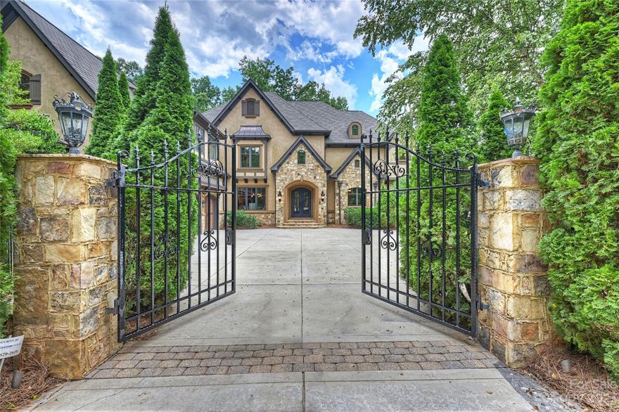 Prepare to be swept away by this exquisite custom home! Boasting exceptional craftsmanship and luxurious features throughout, this home features primary bedrooms on both the main and upper levels, a chef's kitchen, an elevator shaft, expansive living spaces, custom closets and shelving and 4 fireplaces! The spa-like baths feature rain showers, a steam shower, and indulgent whirlpool tubs. Entertainment options abound with wet bars located in the primary bedroom, bonus room, and movie room. All secondary bedrooms feature ensuite baths. The inlaid hardwood floors, elegant ceilings and moldings, grand chandeliers and attention to detail make this home truly exceptional. Dedicated home office and multiple bonus rooms offer endless possibilities. Enjoy beautiful views of the pond and walking trails from your covered back porch and sunporch. Union County's premier gated community offers 40 acres of green space, walking trails, a pool, and tennis courts! NOW SHOWING FOR BACKUP OFFERS!