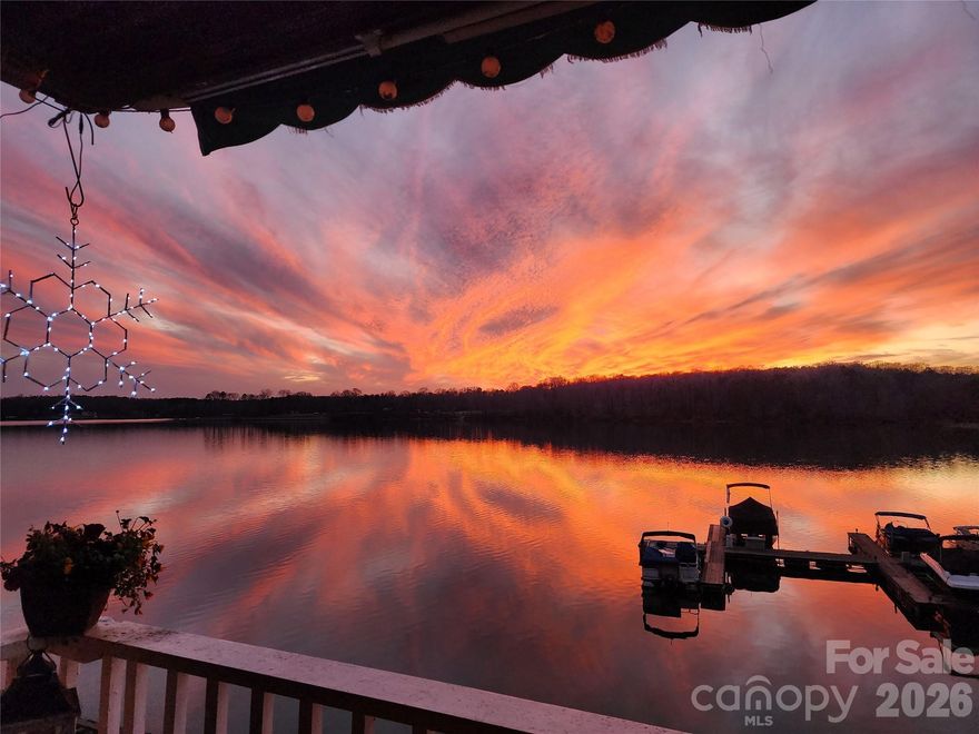 RARE MILLION DOLLAR OPEN WATER VIEW FROM 2 LARGE DECKS. DEDICATED ASSIGNED BOAT SLIP INCLUDED WITH THE UNIT. Serene waterfront living at its finest with West facing unparalleled sunset views!  This 2-story end unit boasts new flooring, fresh paint, new stainless steel appliances, new fixtures, decks & trim and newer upper HVAC unit!! Boat slip #58 is located at the right end of the marina for easy lake access. The front door with new storm door opens to the foyer and eye-catching kitchen with eat up bar. Additional shelving in the dining area stores all your entertaining needs. Open living room with stone accented fireplaces opens to the the upper deck and marina views. Primary BR has built-in storage, plantation shutters and wonderful water views! The tile bath offers a double vanity, jetted soaking tub, separate tiled shower with glass enclosure and huge walk-in closet. The second BR has a double closet with a full bath and laundry closet located in the hallway. The lower level was designed with entertaining in mind! There's plenty of room for living areas, game room, an entertainment bar and half bath. Sliding glass doors open to the deck with storage closet, spiral staircase to the upper deck and access to the boardwalk. Emerald Point offers residents a community pool. kayak/paddleboard storage, marina, boardwalk and exceptional Lake views!! Boat slip # 58 is assigned and conveys with the property. Unbeatable location minutes to the airport, Charlotte Premium Outlets, dining and I-485 access. Just a short boat ride from the 2026 HGTV Dream Home! Based on recent sales the units priced to allow for customization to create your own lakeside retreat. Lower level square footage allows for a potential third bedroom and flex space, with a half bath already in place. ** Please note some photos are virtually staged**