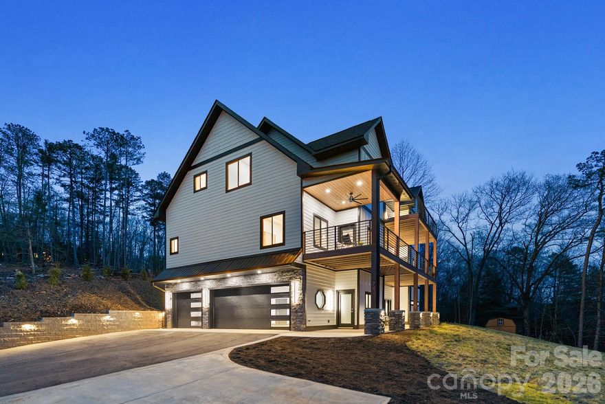 Luxury mountain living just minutes from Pisgah National Forest.
Located one mile from Turkey Pen Gap Trailhead and a short drive to Brevard, Hendersonville, and Asheville. This beautifully designed 4,000+ sq ft mountain home offers fireplaces, spa-like bathrooms, outdoor entertaining spaces, and year round mountain views all surrounded by some of the best hiking and biking in Western North Carolina. Imagine waking up to mountain views and stepping outside to some of the best outdoor recreation in Western North Carolina with hiking, mountain biking, river walks, and horseback riding practically in your backyard.

The first level welcomes you with a stone fireplace and built-ins, creating a cozy living area that could also function as a game room or entertainment space. There is plenty of room for a pool table, lounge seating, or even a bar area for hosting gatherings and celebrations. This level also features an additional primary bedroom suite with a corner fireplace and sliding doors that lead directly to the patio that is already set up for a future hot tub. The spacious spa-inspired bathroom includes dual vanities and a dramatic walk in shower that surrounds a soaking tub, creating a true retreat experience. A large walk in closet with washer and dryer hookups makes this level perfect for a guest suite or in-law living area.
As the illuminated staircase leads you upstairs, the second level opens up to beautiful south facing mountain views. The chef’s kitchen is the centerpiece of the home, anchored by a stunning waterfall granite island designed for cooking, gathering, and entertaining. CAFÉ™ ENERGY STAR® appliances, a hidden pantry, stainless range hood, and pot filler add convenience while maintaining a sleek, modern aesthetic. Cabinet lighting automatically illuminates when opened, and gold hardware paired with the marble tile backsplash adds a touch of luxury.
French doors open to a large covered deck, creating a seamless indoor/outdoor flow between the kitchen, dining area, living room, and outdoor entertaining space to perfectly host friends or enjoying quiet mountain evenings. A second laundry room and half bath are also located on this level for added convenience.
The main-level primary suite features a fireplace with a comfortable seating area and stunning mountain views right from your bed. The en-suite bathroom offers a soaking tub, large walk-in shower, and generous space to unwind after a day exploring the mountains. Two separate closets provide abundant storage for seasonal wardrobes and linens.
The third level offers incredible flexibility for modern living. A bright area at the top of the stairs works perfectly as an office, reading nook, or creative workspace. Nearby, a spacious room could serve as a fourth bedroom, studio, nursery, or additional office space, complete with a walk-in closet and nearby full bathroom.
Another large room on this level offers the perfect bonus space for a family room, game room, or kids’ hangout. French doors lead to a private deck where you can enjoy long-range mountain views year-round.
Also on this level is the third bedroom suite, featuring its own fireplace, seating area, walk-in closet, and private bathroom with dual sinks and a walk-in shower.
Outdoor living is just as impressive as the interior. Multiple decks and patios create inviting spaces to relax and take in the surrounding mountain scenery. The landscaping is designed for low maintenance living, while arborvitae trees provide backyard privacy without blocking the front mountain views.
Schedule your showing today and experience mountain living at its best.