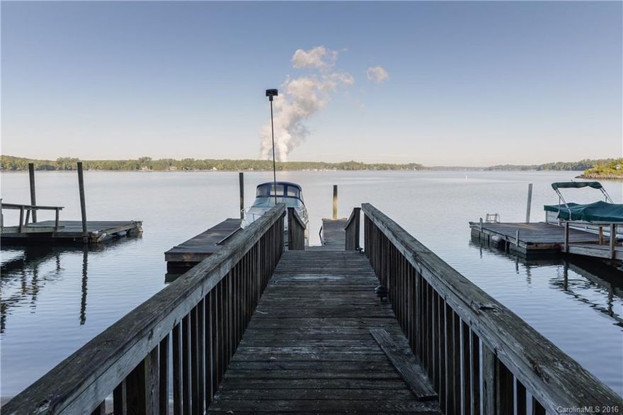 HUGE EQUITY opportunity Reduced on the lake! Own a piece of Tega Cay history w/ phenomenal Lake views. Addition by renown architect Harvey Gantt makes this truly a one of a kind property. Split upper level - office & loft, plus owner's suite. Dining room and eat in kitchen on main level. Lower level - 2 bedrooms and a 2 level family room with floor to ceiling built in bookshelves, fireplace, entertainment bar. Rec room in the basement! Dock. TLC + your personal touches = EQUITY!