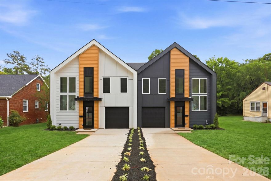 Just steps from the electric energy of Camp North End, this stunning new construction townhome delivers the perfect blend of modern architecture, thoughtful design, and unbeatable urban lifestyle. The bold dual-tone exterior with warm cedar accents and dramatic black garage door sets the tone for everything inside. Natural light floods every corner through oversized windows throughout, highlighting the open-concept floor plan that flows seamlessly from the foyer through the living, dining, and kitchen. With 9-foot ceilings, gorgeous LVP flooring, designer lighting, and custom molding details demonstrate the intentional craftsmanship found at every turn. The chef's kitchen stuns with a large island, premium quartz Palisades Gold countertops, shaker cabinetry, open floating shelves, and stainless steel appliances — opening beautifully to both the dining and living areas. Upstairs, the primary suite is a true retreat featuring a soaring tray ceiling, oversized walk-in closet, and a breathtaking primary bath with dual vanities, large-format designer tile, and a frameless glass walk-in shower. Two additional bedrooms, a dedicated office with built-in shelving, full laundry room, and a beautifully finished second bath complete the upper level.