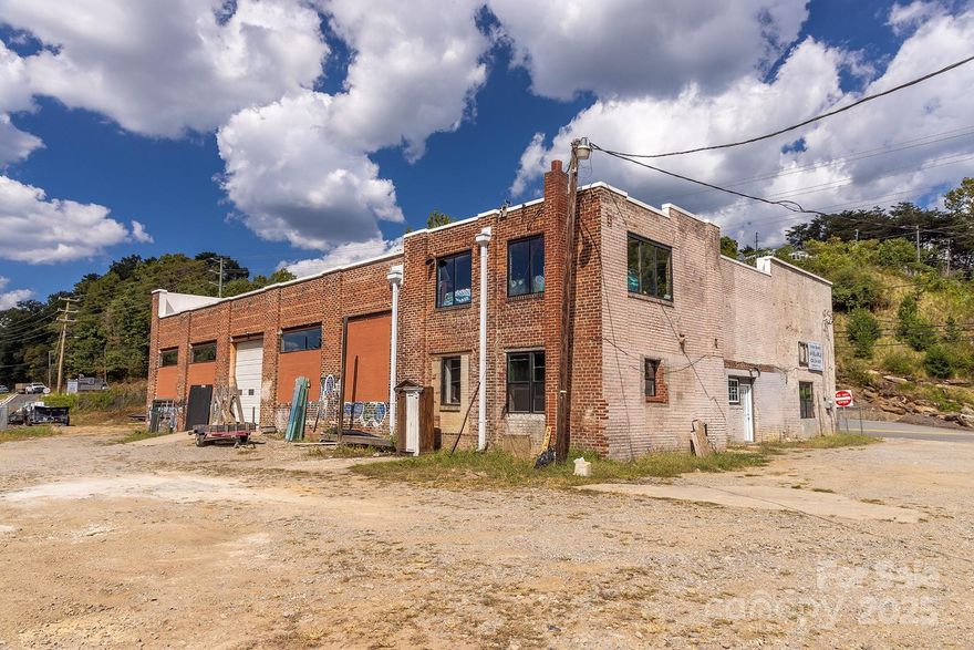 SELLER FINANCING CONSIDERED ; Beautiful brick Building located N. River Arts District in Woodfin Zoning District. Ideal location for warehouse, mixed storage, multiple commercial uses. New Roof. Additional storage buildings on site. abuts railroad spur w minimal setbacks and is fenced. SELLER to consider Lease option or lease purchase on  Brick Building approx. 6,000 sq ft for $6,000 mo. terms to be negotiated.
