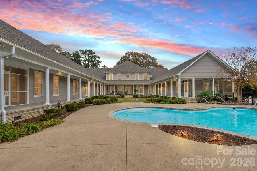 Discover an uncompromising level of Southern luxury in this extraordinary 10,000+ sq ft estate set on 10 peaceful and private acres in Kershaw, ideally positioned between the historic charm of Camden and the convenience of Lancaster. A beautifully designed circle drive—finished with elegant pavers at the entrance—guides you past the stately port-cochère and into this distinguished residence, accompanied by three complementary structures: an all-brick workshop, a classic barn, and a charming outbuilding.
Inside, sophistication unfolds across expansive living spaces, where refined craftsmanship and timeless architectural details create an atmosphere of quiet grandeur. The home boasts three full kitchens in the main house and multiple laundry rooms, offering unmatched convenience and versatility for hosting, multigenerational living, or everyday ease. Three distinct wings provide flexibility for guests, private offices, or creative spaces, while a private in-law suite features its own garage and separate entrance for added independence.
The primary suite is a sanctuary of its own, complete with a private library and luxurious his-and-hers bathrooms, each thoughtfully designed for ultimate comfort and indulgence. The dramatic foyer, framed by soaring ceilings, features a light lift providing effortless access to the chandelier—a refined touch perfectly suited to an estate of this caliber.
Outdoor living takes center stage. A sparkling, heated, and chlorinated pool is complemented by an impressive pool house offering a full kitchen, full bath, wood-burning fireplace, and outdoor shower. Beneath the pool house, a pull-through garage adds both convenience and functionality. Multiple screened-in porches invite seamless indoor-outdoor living throughout the seasons.
This remarkable property features 8 bedrooms, 9 full bathrooms, and 2 half baths, ensuring ample space for family, guests, and hosting in complete comfort. The home is further enhanced by numerous recent upgrades, including a new roof (2025), six HVAC units (two from 2020, one from 2021, one from 2022, one from 2025, and the pool house unit from 2009), and five water heaters—three tankless units from 2020 and two 40-gallon electric water heaters from 2009.
Please note: the property’s well pump is not currently operational.
A rare offering of privacy, craftsmanship, and timeless Southern elegance, this estate is more than a home—it is a lifestyle, a retreat, and a legacy. Due to limited photos in MLS, ask your agent for an unbranded link to view all photos.
