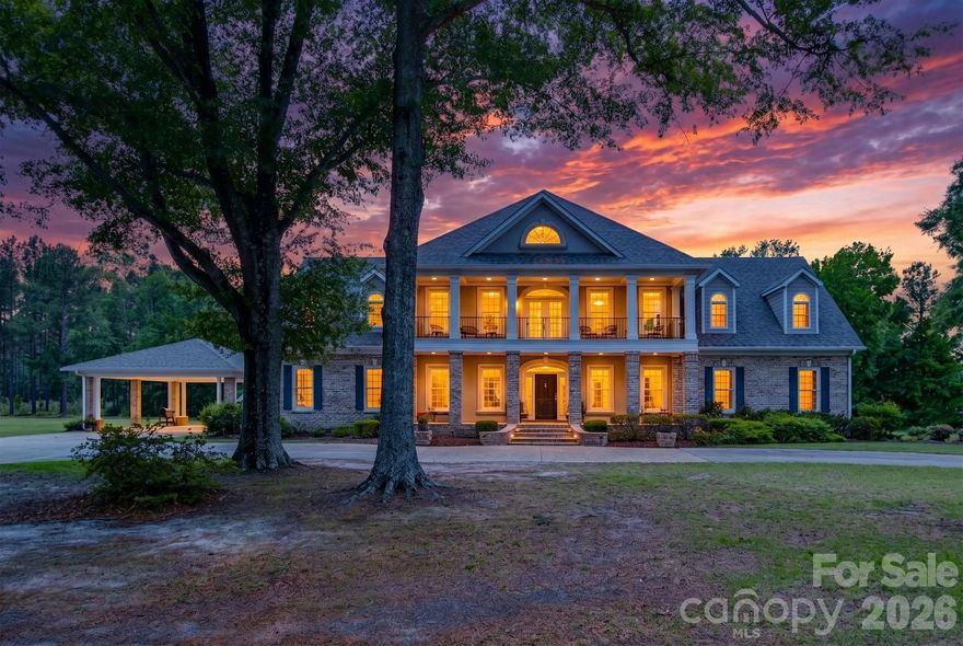 Discover an uncompromising level of Southern luxury in this extraordinary 10,000+ sq ft estate set on 10 peaceful and private acres in Kershaw, ideally positioned between the historic charm of Camden and the convenience of Lancaster. A beautifully designed circle drive—finished with elegant pavers at the entrance—guides you past the stately port-cochère and into this distinguished residence, accompanied by three complementary structures: an all-brick workshop, a classic barn, and a charming outbuilding.
Inside, sophistication unfolds across expansive living spaces, where refined craftsmanship and timeless architectural details create an atmosphere of quiet grandeur. The home boasts three full kitchens in the main house and multiple laundry rooms, offering unmatched convenience and versatility for hosting, multigenerational living, or everyday ease. Three distinct wings provide flexibility for guests, private offices, or creative spaces, while a private in-law suite features its own garage and separate entrance for added independence.
The primary suite is a sanctuary of its own, complete with a private library and luxurious his-and-hers bathrooms, each thoughtfully designed for ultimate comfort and indulgence. The dramatic foyer, framed by soaring ceilings, features a light lift providing effortless access to the chandelier—a refined touch perfectly suited to an estate of this caliber.
Outdoor living takes center stage. A sparkling, heated, and chlorinated pool is complemented by an impressive pool house offering a full kitchen, full bath, wood-burning fireplace, and outdoor shower. Beneath the pool house, a pull-through garage adds both convenience and functionality. Multiple screened-in porches invite seamless indoor-outdoor living throughout the seasons.
This remarkable property features 8 bedrooms, 9 full bathrooms, and 2 half baths, ensuring ample space for family, guests, and hosting in complete comfort. The home is further enhanced by numerous recent upgrades, including a new roof (2025), six HVAC units (two from 2020, one from 2021, one from 2022, one from 2025, and the pool house unit from 2009), and five water heaters—three tankless units from 2020 and two 40-gallon electric water heaters from 2009.
Please note: the property’s well pump is not currently operational.
A rare offering of privacy, craftsmanship, and timeless Southern elegance, this estate is more than a home—it is a lifestyle, a retreat, and a legacy. Due to limited photos in MLS, ask your agent for an unbranded link to view all photos.