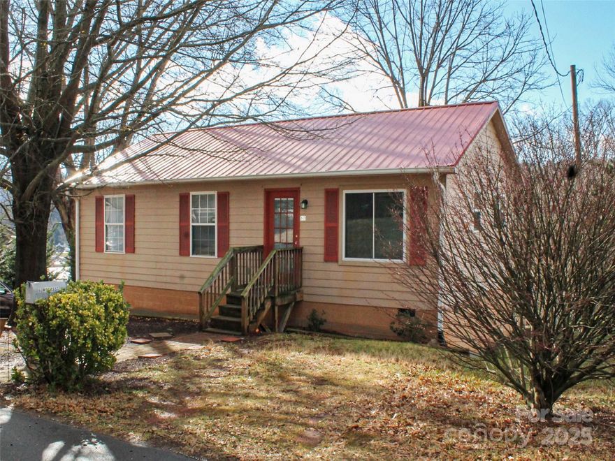 Tucked away on a quiet dead-end road, this charming cottage is a fantastic find! With a cozy and welcoming vibe, it features a metal roof, plenty of natural light, and warm wood flooring. The kitchen island adds a touch of convenience, while the covered back porch offers beautiful mountain views especially stunning in the winter. The fenced-in yard makes it practical and inviting, perfect for enjoying the peaceful surroundings. A simple yet delightful place to call home!