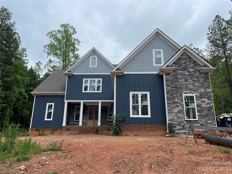 Gorgeous custom home built with Clover schools. This house has all kinds of luxurious upgrades. Huge kitchen with tons of cabinets, huge island, large eating area, and gas range. Primary bedroom on main with oversized shower, separate tub and custom closet. Upstairs 3 additional large bedrooms and oversized bonus room. Tons of storage in this house. Lots of shiplap, built ins in the great room, drop zone with built ins and a separate pantry room. Back screen porch and 3 car garage. Beautiful lot with lots of trees around it. Plenty of room in the back for buyers to add a pool. Home should be complete within about 90 days of listing. Photo for illustration purposes. House being photographed June 2.