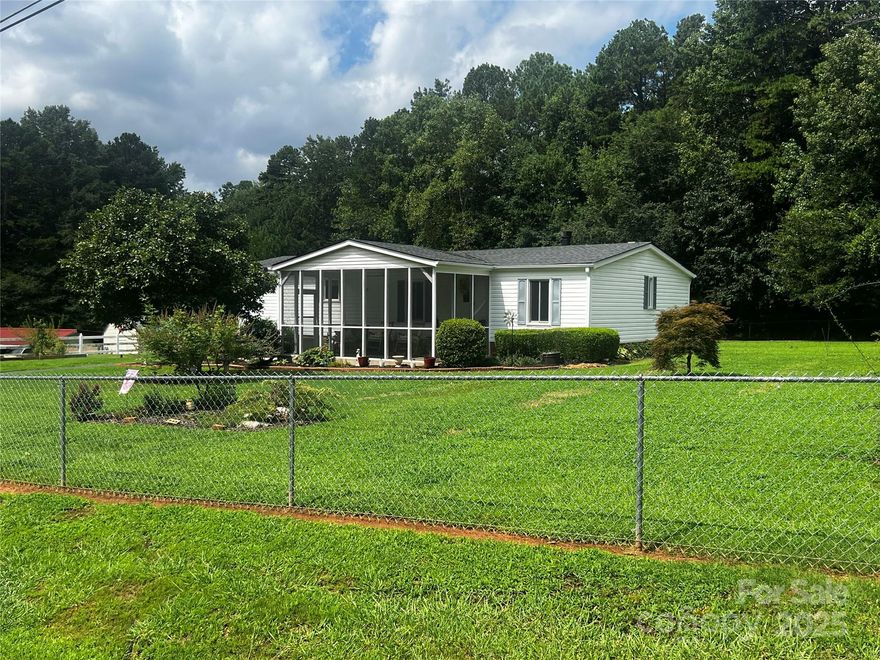 Absolutely Beautiful at a very low price. Home on a permanant foundation. Huge fenced yard, No HOA. Home has a very large detached garage, work shop, extra room for storage, and a covered carport and storage area. The lot is tremendously large a must see! Home has a wonderful front screen porch to relax in rocking chairs and enjoy. Inside the home has many upgrades with brand new doors, Newly redone bathrooms with customer shower as seen in photos, and seller states new roof was in approx. 2019 and new hvac only about 10 years old. The home has brand new Anderson windows and warranty is transferable. This one will sale quick!