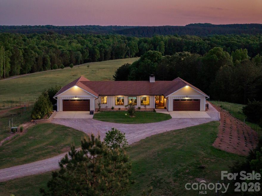 Once one of the premier Bison farms in the US, this extraordinary 215-acre private estate, is a rare and compelling offering where refined modern living and a fully realized agricultural landscape converge. Equal parts sanctuary and statement, this property has been thoughtfully designed for those who demand beauty,privacy and performance. An enduring oasis for true generational living.Completed in 2022, the residence reflects a quiet, confident sophistication. Inside, rich natural stone surfaces—polished granite, marble, and quartzite—are seamlessly integrated throughout, complementing a chef-inspired kitchen appointed with premium stainless appliances and a sleek induction range. The home’s construction speaks to a higher standard, with enhanced insulation, solid core doors, and advanced systems that deliver both comfort and efficiency without compromise.
The living spaces are both grand and inviting, anchored by a wood-burning insert fireplace that creates a warm, inviting atmosphere while effortlessly heating the home. Just beyond the stacking glass doors, a resort-style pool is set against a backdrop of lush grounds—offering a private, tranquil setting for entertaining or quiet retreat. Two generous garages offering 3.5 parking spaces and EV-ready infrastructure further reflect the home’s forward-thinking design.This estate has practiced regenerative farming since the beginning, a stewardship of the land unmatched . Rolling pastures unfold across the property, thoughtfully divided into multiple grazing sections and secured with extensive fencing—creating a turnkey environment for equestrian pursuits or livestock operations. Over 90 acres of mature woodland provide a striking natural buffer, enhancing both privacy and the grandeur. Relax listening to the three pristine streams weave their way across the property.Multiple wells deliver abundant water across the estate, supporting irrigation, livestock. A large open-air pavilion offers space for gatherings, events, or operational use, while additional improvements—including roads, storage facilities, fiber connectivity, ensure the property is as capable as it is beautiful.A charming White Pine cabin provides a refined yet rustic escape—ideal for guests, a caretaker’s residence, or income-producing potential. Thoughtfully equipped with modern conveniences and a covered deck, it captures the essence of relaxed, elevated country living.With no floodplain limitations, the estate offers both immediate enjoyment and long-term investment strength. Rich in character and history—having served as a filming location for The Patriot—this is a property that resonates far beyond its acreage.
8088 Kays Drive is not simply a home—it is a legacy estate. A place where luxury, land, and lifestyle exist in perfect balance, offering a truly rare opportunity to own one of the region’s most distinctive and complete properties.