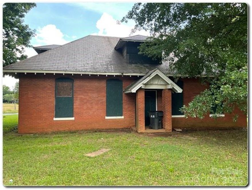 Incredible Opportunity to Own a Piece of Charlotte History! This charming 2-story brick building was once the original General Store for the Hoskins Mill community in the early 1900s. Bursting with historical character, it features an original slate roof, hand-etched safe, window moldings, exposed brick walls, and a stunning atrium—all perfect for incorporating into your renovation plans. The current development plan includes two 2-bedroom/2-bath units upstairs and four 1-bedroom/1-bath units with a shared common area downstairs. Located just minutes from Uptown Charlotte, this property offers rich history, architectural charm, and excellent potential for residential income or creative redevelopment. No Utilities are present and City Water/Sewer connections are needed, but not present.