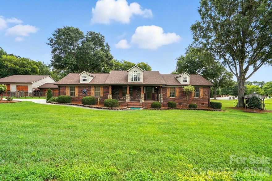 Discover this unique Concord property featuring a full-brick 2BR/2BA main home with lodge-style charm, hardwoods, tile, and stone accents. Enjoy the spacious covered front porch and an oversized back porch with fireplace and mounted TV. The fenced backyard offers a patio, gazebo, and a historic 1800s cabin relocated from downtown Concord. Car enthusiasts will love the expansive main garage with HVAC, office, half bath and lifts—plus room for 10+ vehicles, plus carport space. Sitting on 1.2 acres with no HOA, this property is ideal for those seeking versatile living and unmatched garage space.

Small carport in front of large garage shown in photos has been removed and will not convey.