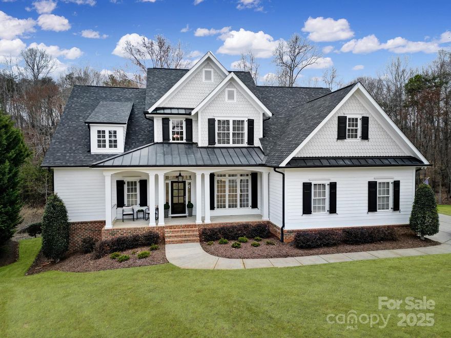 This quintessential southern charmer, located in the highly desired Springfield community is ready for it's new owner. From the moment you pull up to the home you'll be graced with a welcoming front porch. Inside you'll find a grand foyer, a formal dining room, large family room, open kitchen/living room, and spacious primary suite on the main. Upstairs you'll find 3 oversized BRs, 3 BAs and a 4th BR/Bonus room (with additional laundry hook up if you desire on the 2nd floor). After a long day you will love escaping to the peaceful private backyard w/ expansive deck and custom built woodburning fireplace. But wait, there's much more! Downstairs you'll find a finished walk-out basement that includes rec room, BR, BA, storage, gym (that would also make a great media room) and a 4th car garage/workshop! This home has it all- luxury, space, and prime location. Springfield offers tennis courts, 3 pools, pickle ball, playgrounds, walking trails and an Anne Springs Greenway membership.