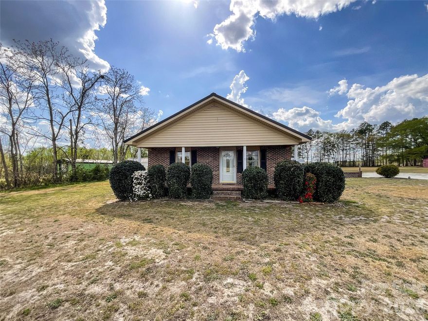 Welcome home to your own slice of peaceful country living in charming Ruby, SC! Nestled on an expansive 6.2 acres, this delightful 3-bedroom, 1-bath home offers 1,154 sq ft of cozy, inviting space with room to truly make it your own. Step inside and fall in love with the warm and welcoming layout, centered around a beautiful hearth with electric insert fireplace that creates the perfect gathering spot for relaxing evenings or entertaining guests. Natural light fills the home, adding to its cheerful and comfortable feel. Outside is where this property really shines! Whether you’re dreaming of a mini farm, workshop space, or simply room to roam, you’ll appreciate the impressive 918 sq ft barn/outbuilding; ideal for hobbies, storage, or projects of all kinds. There’s also an additional 144 sq ft shed for even more storage flexibility. Enjoy peace of mind with a durable metal roof that’s less than 10 years old, combining longevity with low maintenance. The generous acreage provides plenty of privacy and freedom; bring your animals, your toys, or your vision and make it a reality! Conveniently located just a short drive from Pageland, SC, you’ll have easy access to local amenities while still enjoying the quiet charm of rural living. If you’ve been searching for space, privacy, and endless potential, this one is calling your name! Don’t miss your opportunity to experience country living at its best!