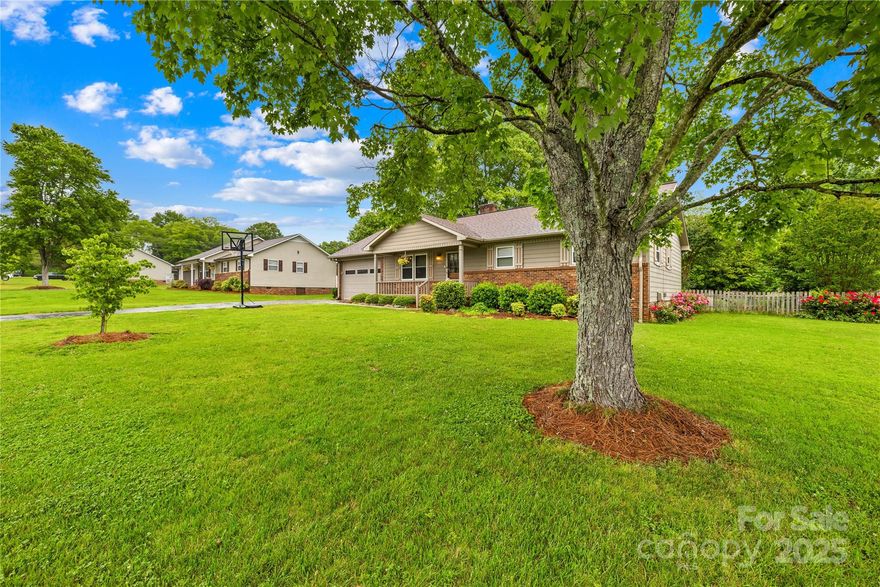 ASSUMABLE LOAN 6.125% ~ Nestled on a quiet, tree-lined street, this delightful 3-bedroom, 2-bath ranch home offers curb appeal with its inviting front porch and mature landscaping. Located just minutes from local schools, parks, shopping, and dining, 117 Ethel Lane combines comfort and convenience in a desirable neighborhood.

Inside, you'll find a  kitchen featuring solid cabinetry, granite countertops, and a stylish tile backsplash. The open layout flows seamlessly into the living areas, perfect for everyday living. The 1-car garage offers ample room for parking or extra storage.

Step out back to a fenced-in, park-like yard bursting with lush flowers and greenery. A large outbuilding provides versatile space for hobbies, a workshop, or additional storage needs.