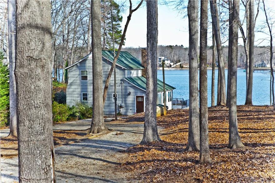 ULTIMATE WATERFRONT COTTAGE living w/potential to attach a larger home. Granite counters, stainless appliances, furniture style vanities, travertine master bath w/walk in shower & 220' SHORELINE. Boat ramp & boat garage/basement. Upscale area w/no HOA but homes around you are in one. Awesome living as is, but huge potential w/expansion, add landscaping, garage, main house, etc. WIDE VIEWS on one of the best water skiing coves. Large wooded lot, private dock & large back deck to enjoy the lake.