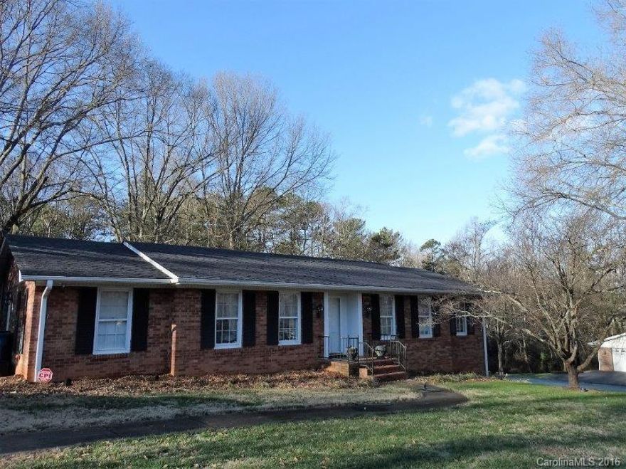 Northwest SHUFORD Area. Custom built brick ranch/two owner on 1.68 a. Traditional floor plan, foyer, formal living & dining, kitchen w/double ovens & white cabinets, den w/fireplace which open onto large sunroom across back w/pine paneling/access to upper driveway. Master bedroom/bath w/shower. Mixture of hardwood, tile and carpet. Lower level area features den/with wood burning fireplace (lower level has no central HV/AC). 1/2 bath, storage room. Access to patio/yard. Double garage (two doors).