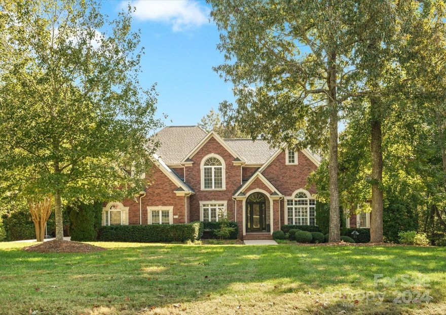 This stunning custom full brick home, complete w/a finished walkout basement, is sure to impress! Nestled on a one-acre lot w/serene wooded views, it boasts a heated saltwater pool for your personal oasis. Enter through the grand 2 story foyer into a spacious layout that includes a private office, dining room w/butler’s pantry & a dream kitchen featuring new hardwood floors, double ovens, new gas cooktop, & custom cabinetry w/spice cabinets, warming drawer & more. Main level offers a primary & guest bedroom, while upstairs you'll find three large bedrooms & a bonus room w/a gas fireplace & wet bar. The basement is a versatile space with a bar/game room, family room w/a stone fireplace & media projector, a craft room/office, & two addt'nl rooms w/closets, offering potential for up to 7 BRs! Relax on screened porch or covered deck while taking in the fall views. Extras include 3 fireplaces, central vac, whole-home speaker system, new roof (2024), 240 watt outlet for car charger & more!